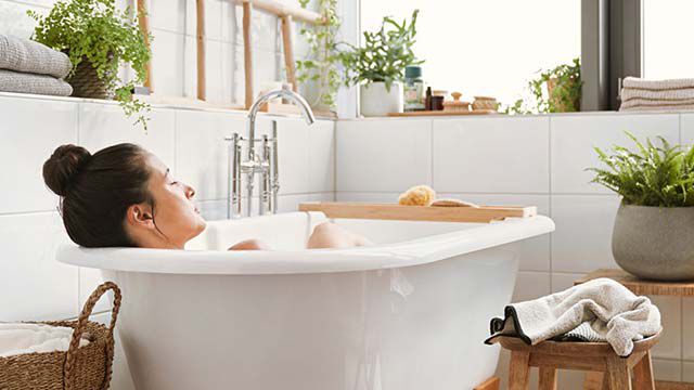 Woman lying in the bathtub and relaxing.