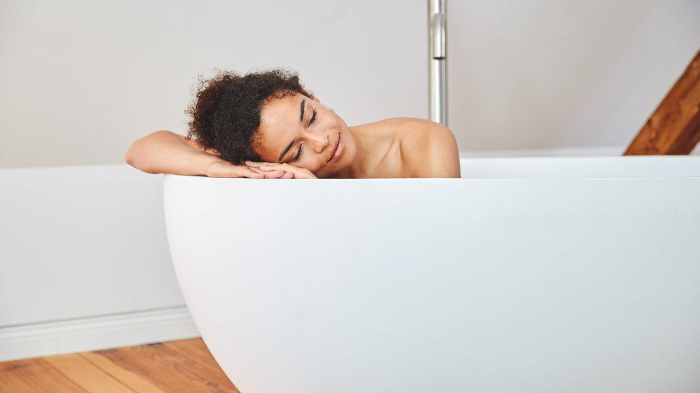 Young woman relaxing in the bathtub