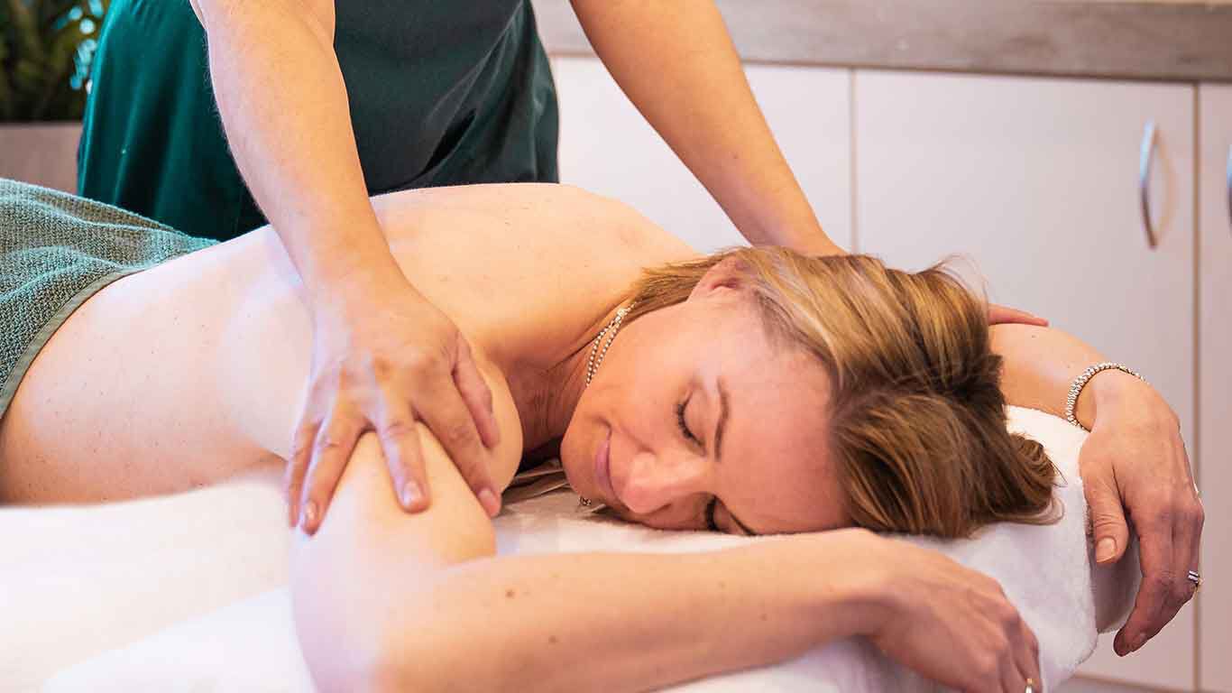 Woman on massage table during massage.
