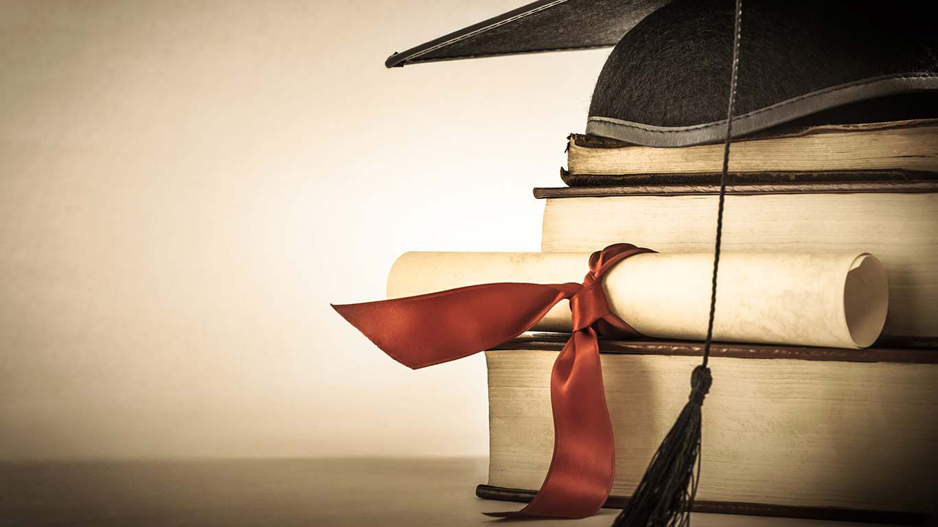 Book stack with graduation hat.